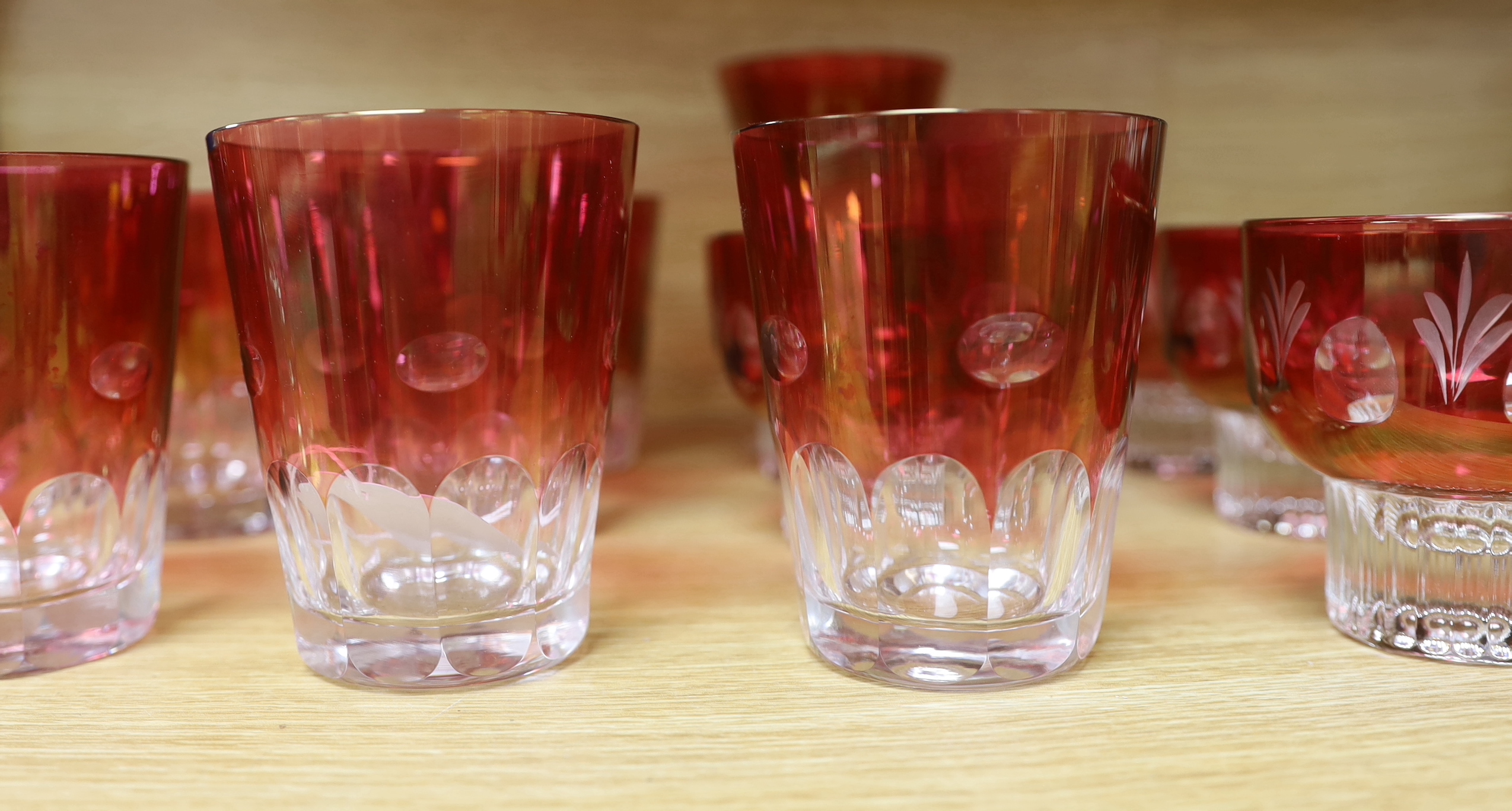 A quantity of cranberry flashed glasses including a set of five, the largest 18cm high